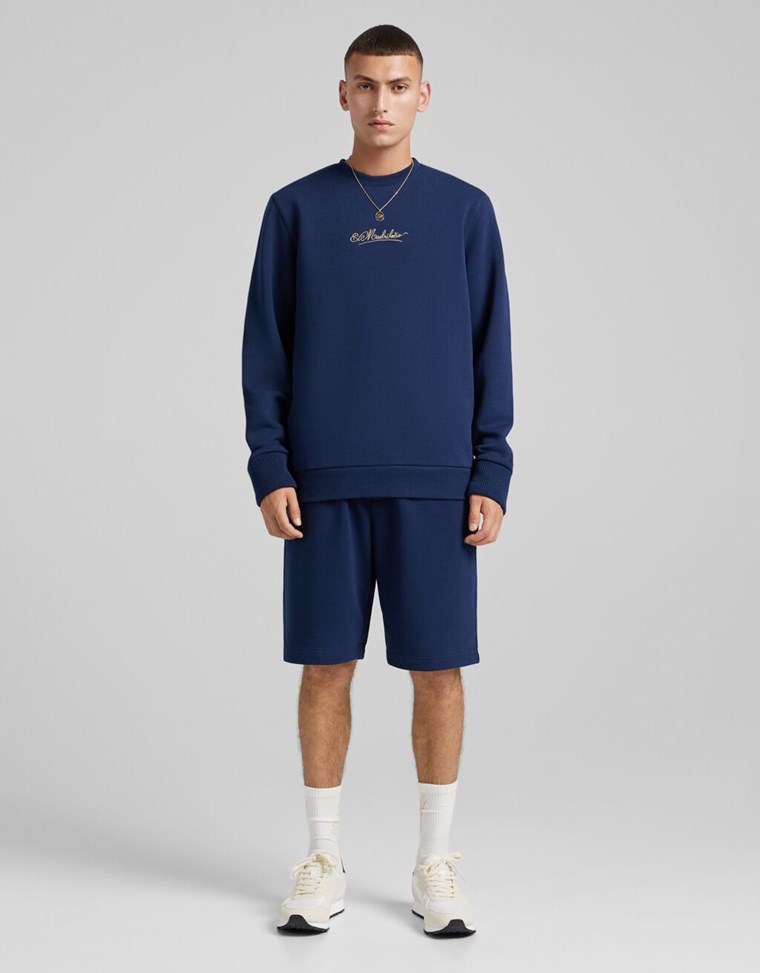 MODEL WEARING A BERSHKA SWEATER