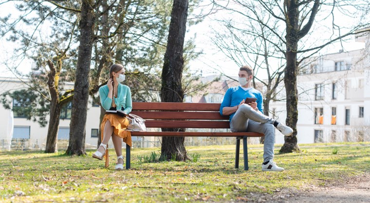 YOUNG WOMAN AND YOUNG MAN IN SOCIAL DISTANCING