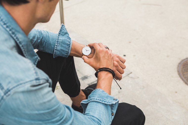 CLOSE-UP ON THE WATCH OF A CASUAL DRESSED MAN